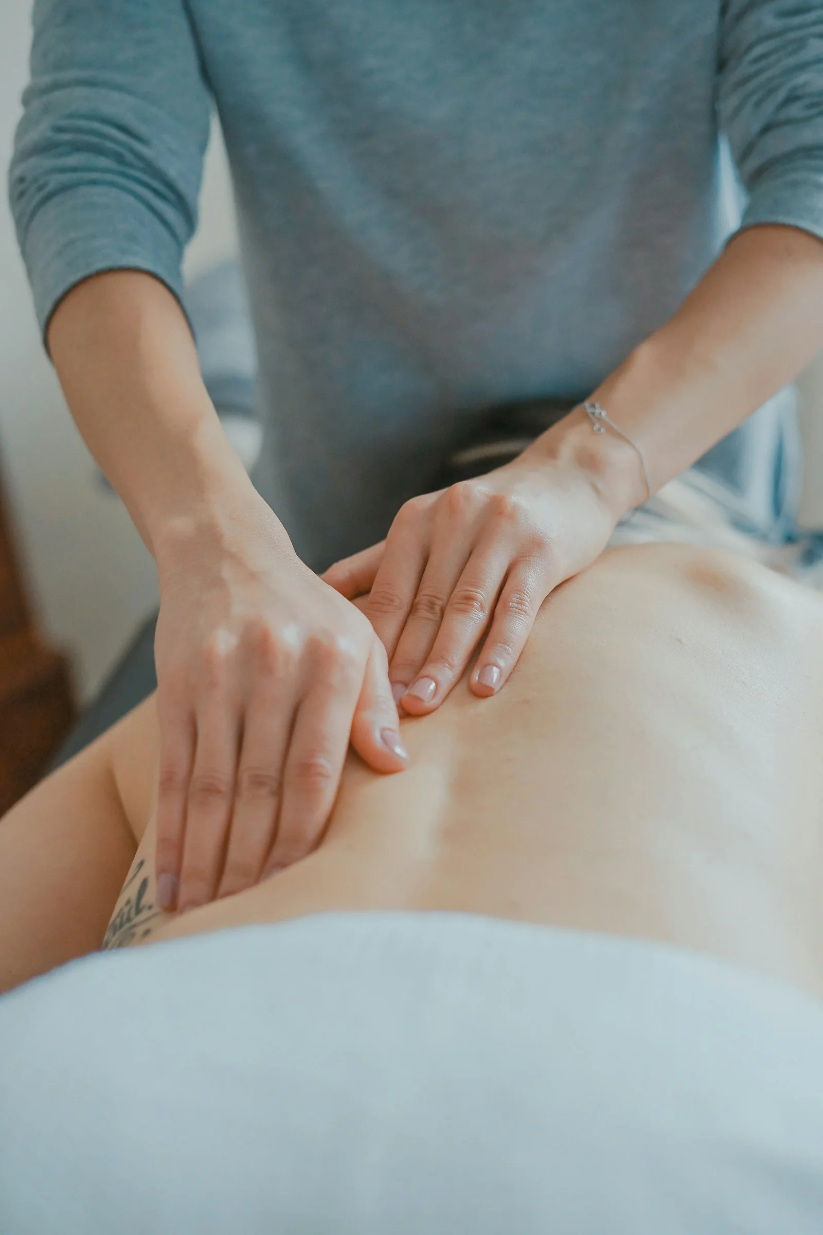 A therapist working carefully on a guest’s back